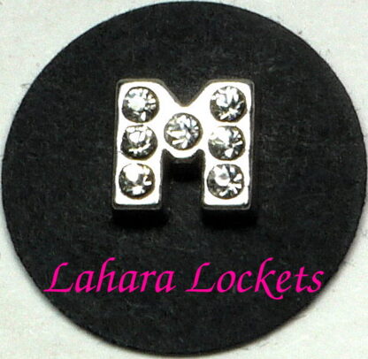 This floating charm is a silver letter M with clear gems.