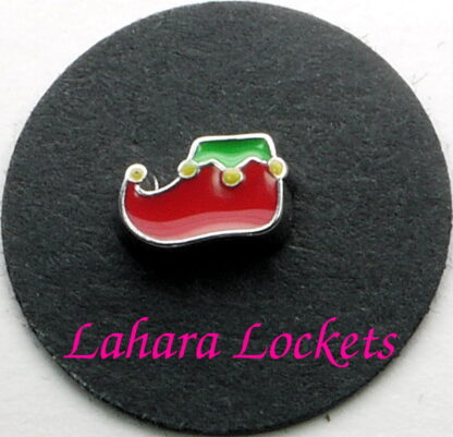 This floating charm is a red, elf shoe with green trim and yellow bells.