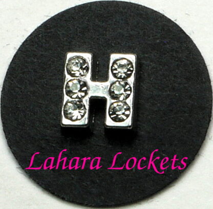 This floating charm is a silver letter H with clear gems.